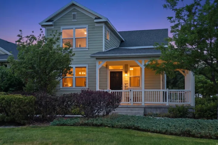Two-story residence featuring light green siding and a dark shingle roof
