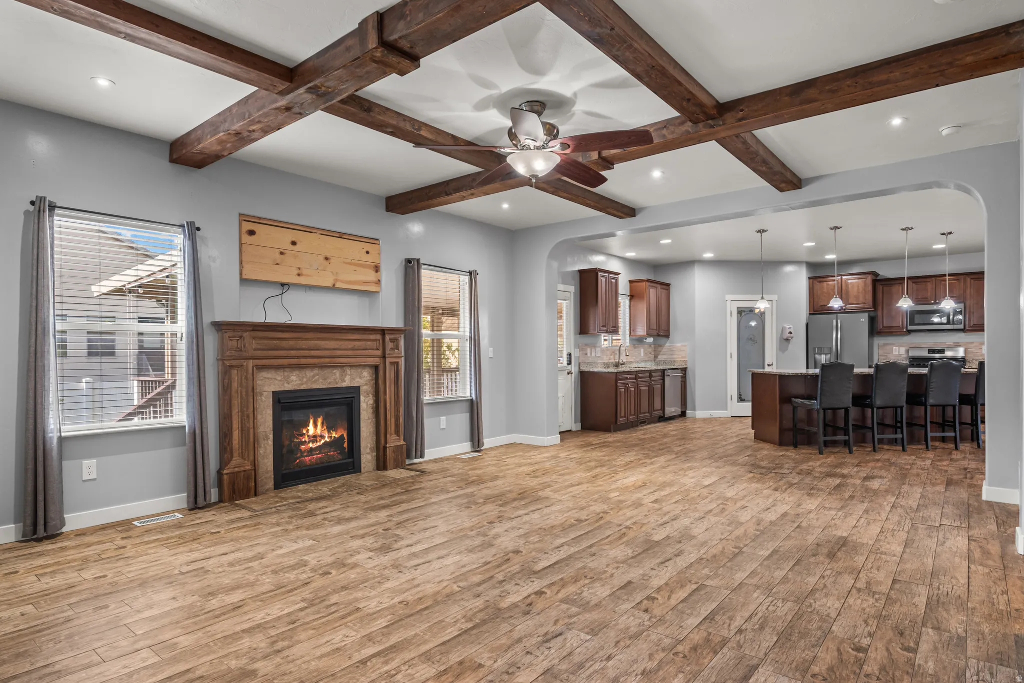 Spacious interior featuring wood-finish flooring and a coffered ceiling with exposed beams