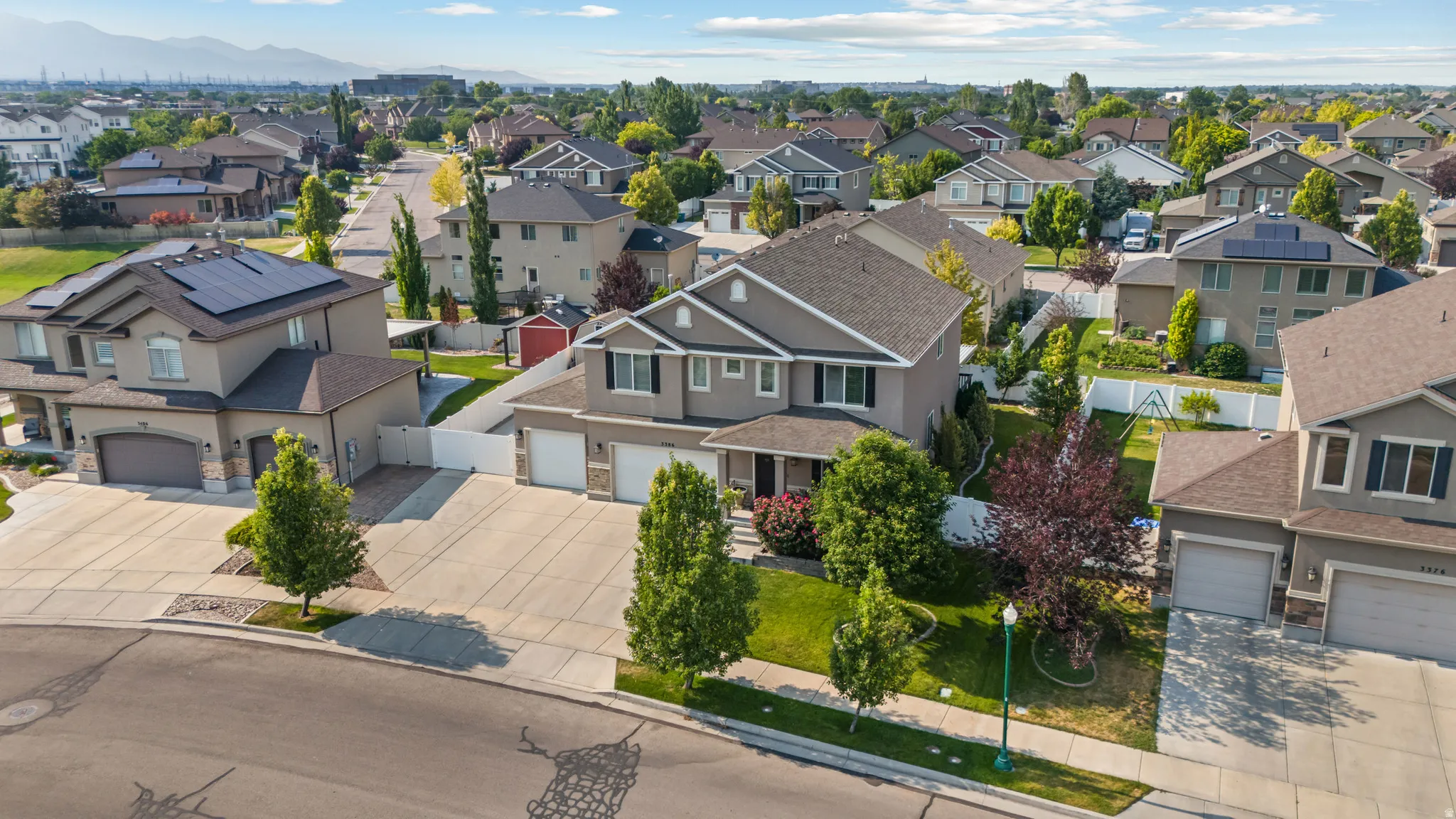 Two-story property featuring a neutral-toned exterior, an attached two-car garage, and a concrete driveway