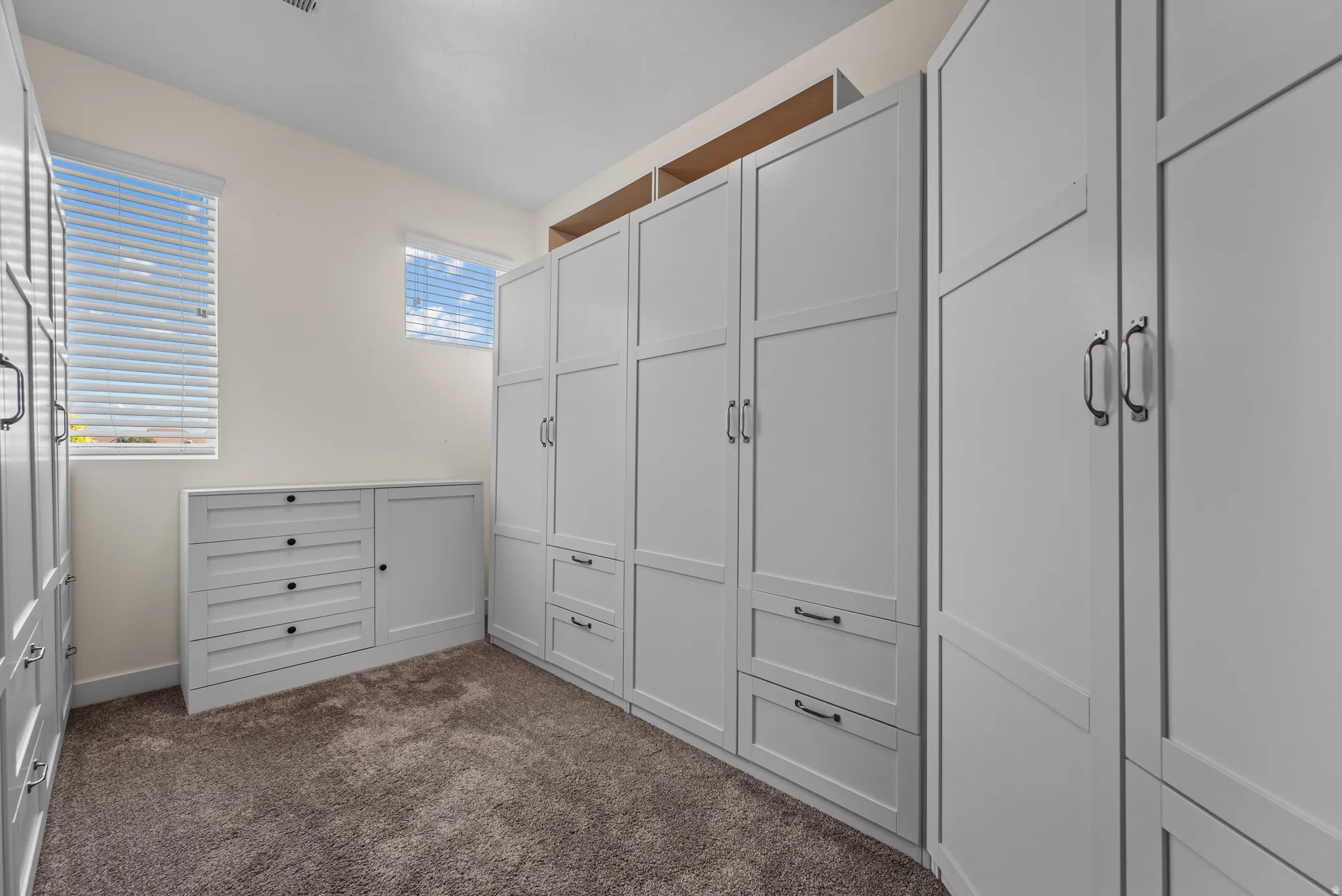 Custom white built-in cabinetry and drawers provide extensive storage
