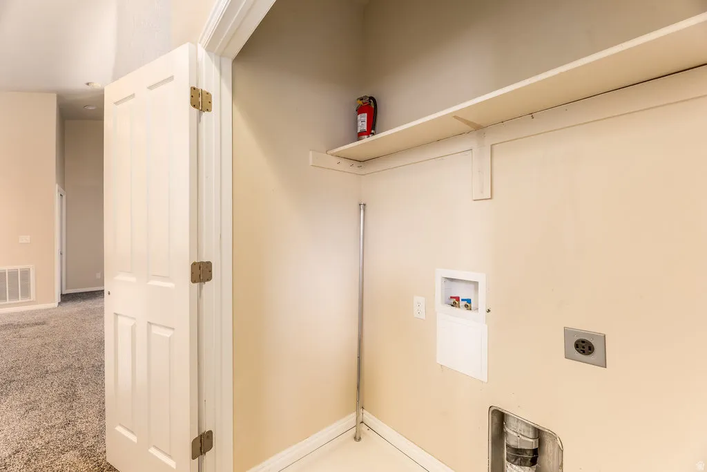 Dedicated utility space featuring a laundry hookup with water lines and a 240V outlet