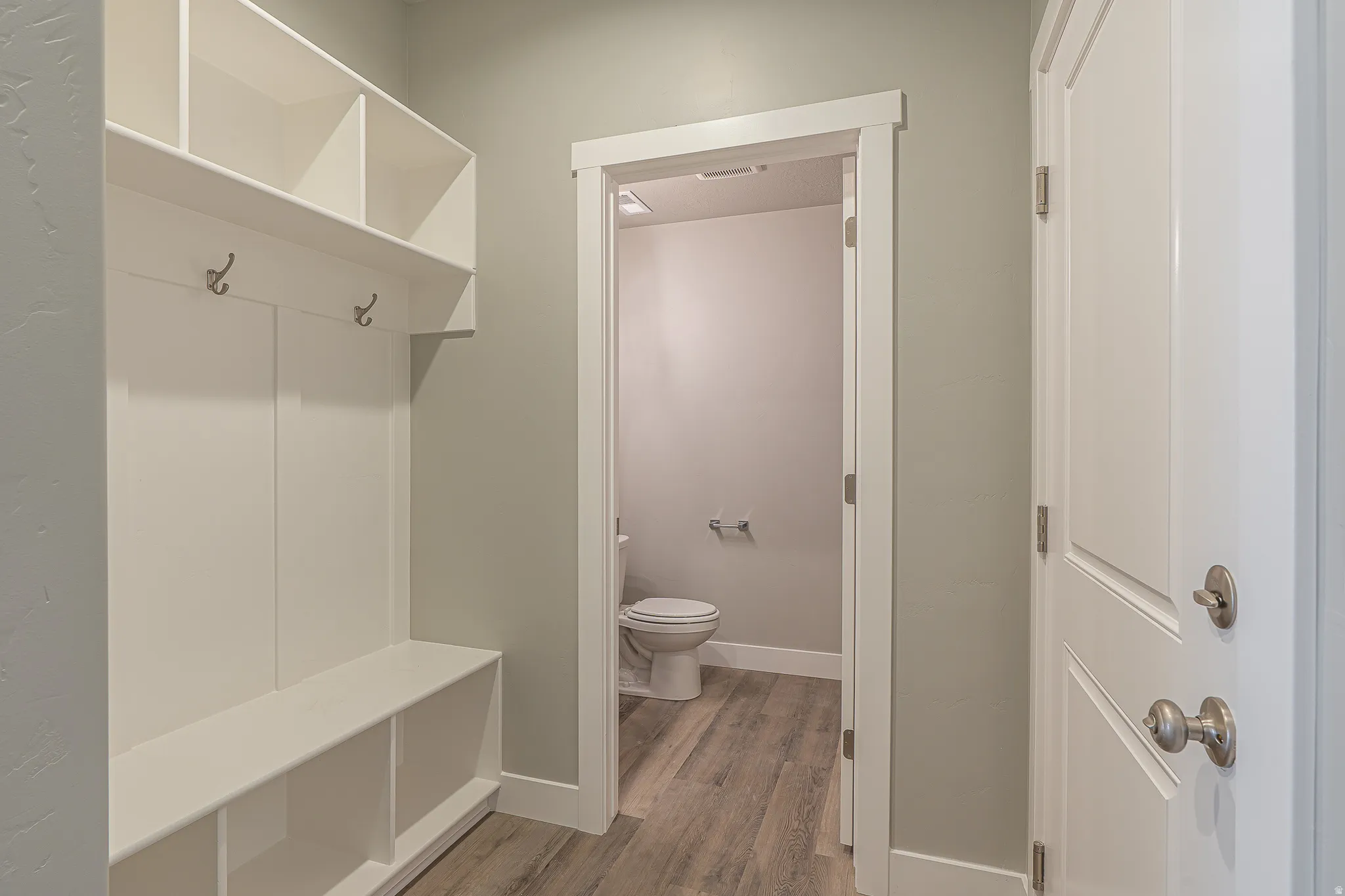 Built-in entry system featuring storage cubbies, bench seating, and wall hooks