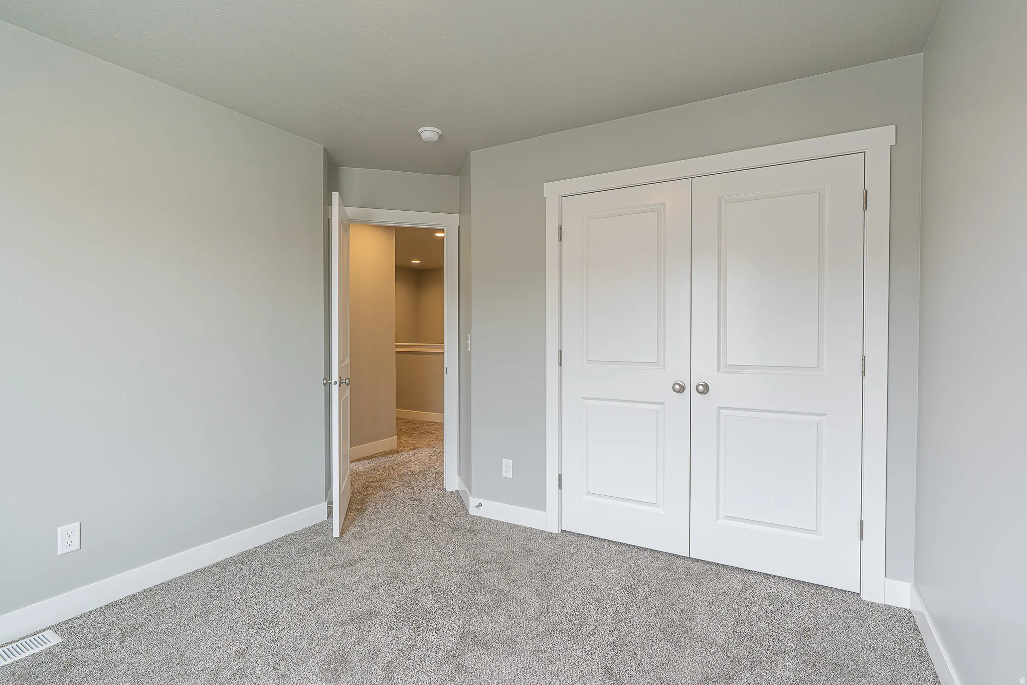 Neutral-toned carpeting throughout the room
