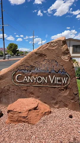 Red rock landscape sign with "Canyon View" engraving and a decorative rock border
