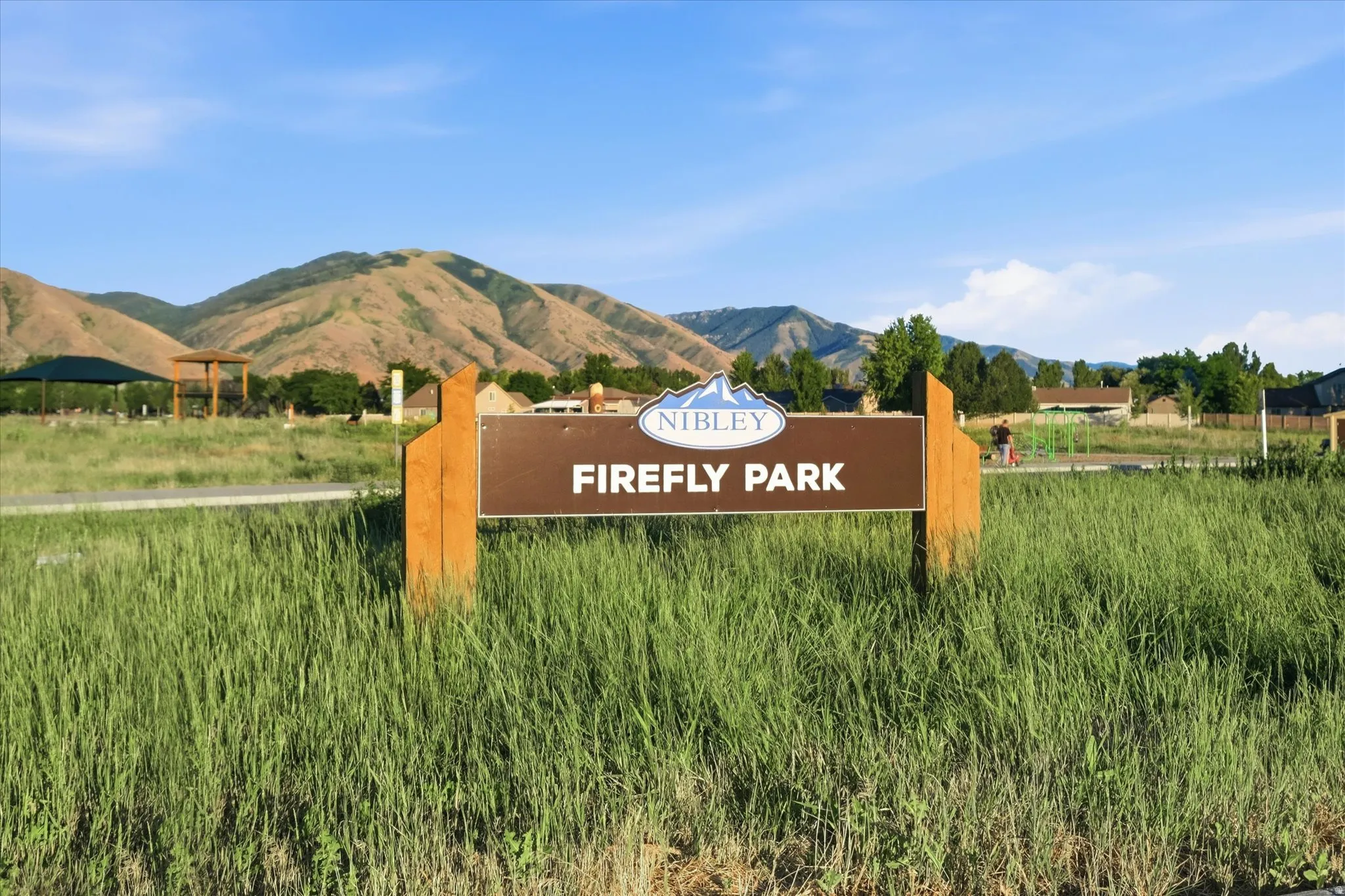 Nibley Firefly Park sign with mountain backdrop