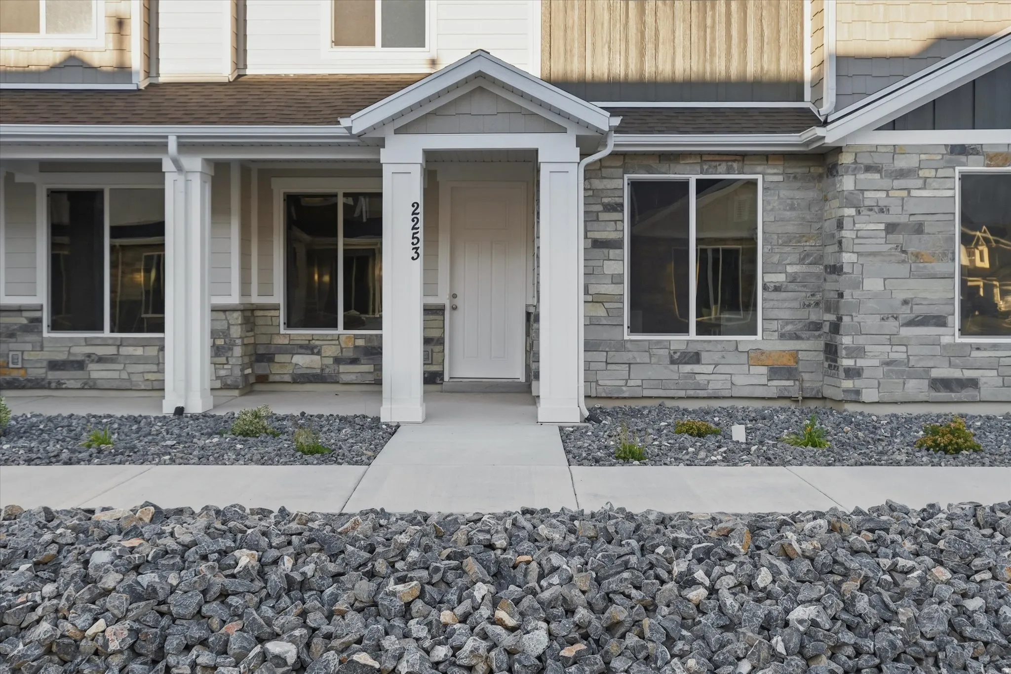 Contemporary exterior featuring stone veneer and horizontal siding