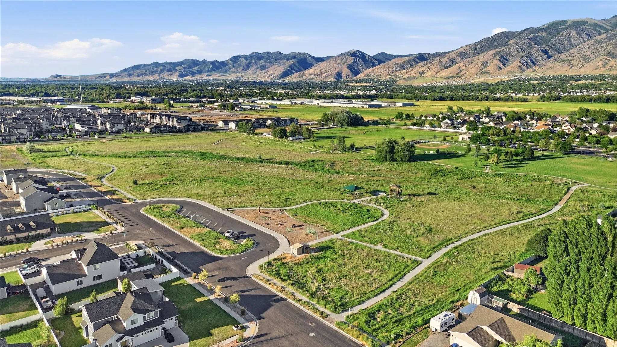 Expansive green spaces and walking paths complement the surrounding residential development
