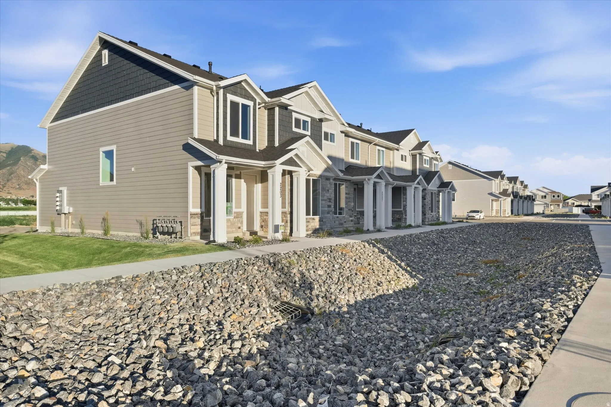 New construction townhome featuring a two-story design with a gabled roof