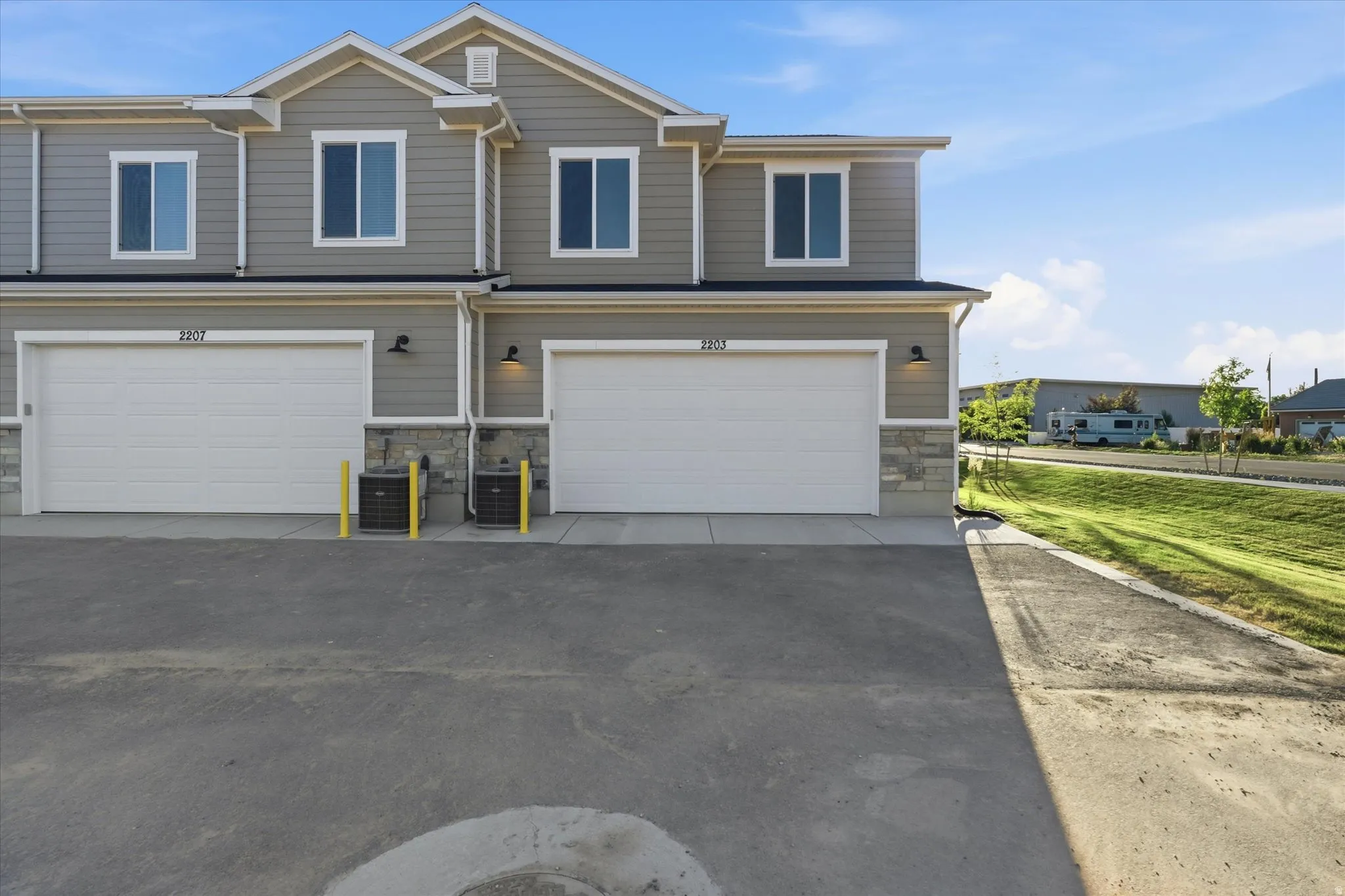 Contemporary multi-level exterior with light gray siding and white trim