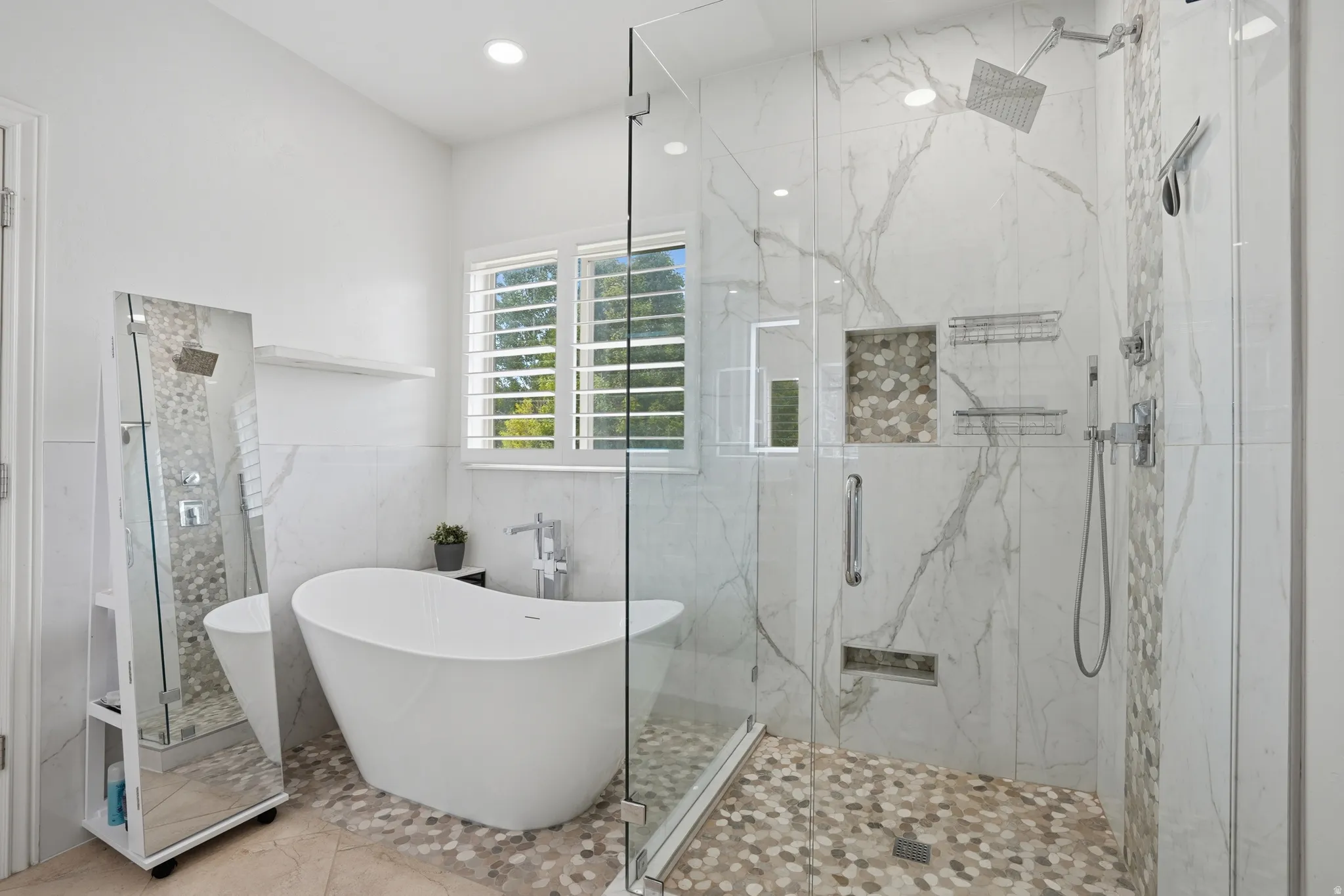 Freestanding soaking tub complemented by a spacious walk-in shower