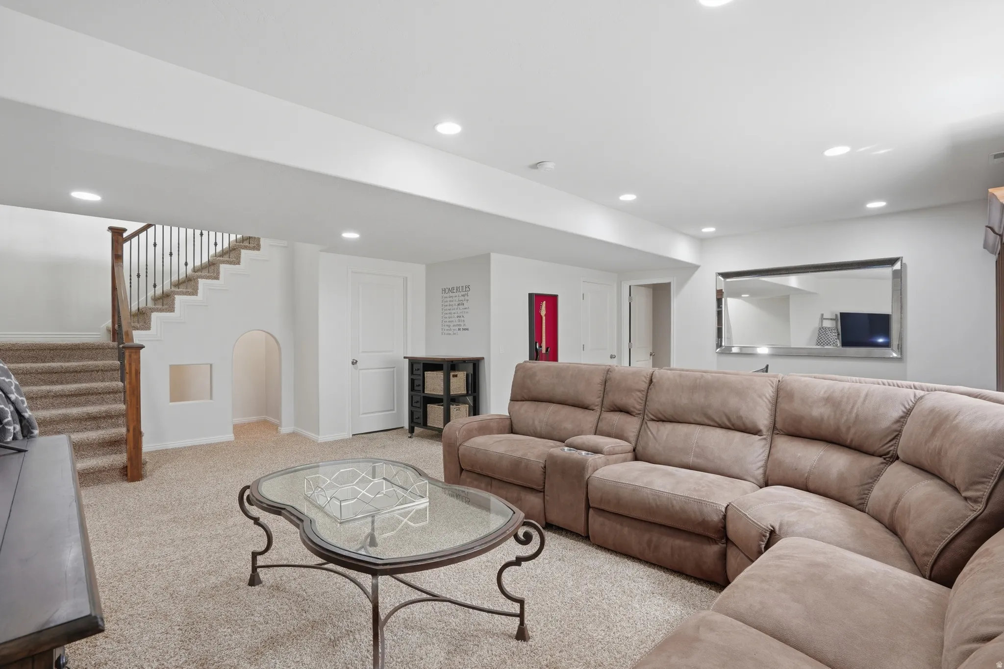 Carpeted lower level featuring recessed lighting and white painted walls
