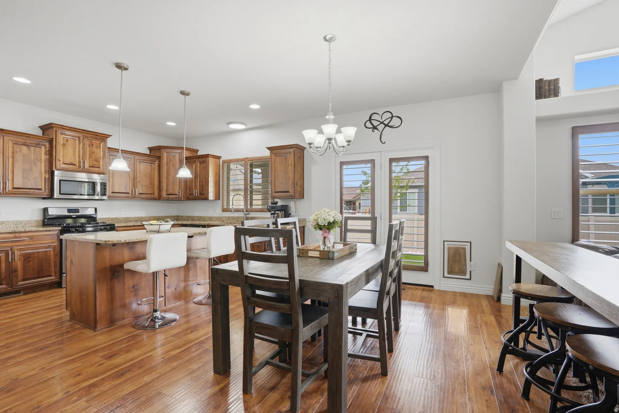 Spacious kitchen and dining area featuring wood-finish flooring