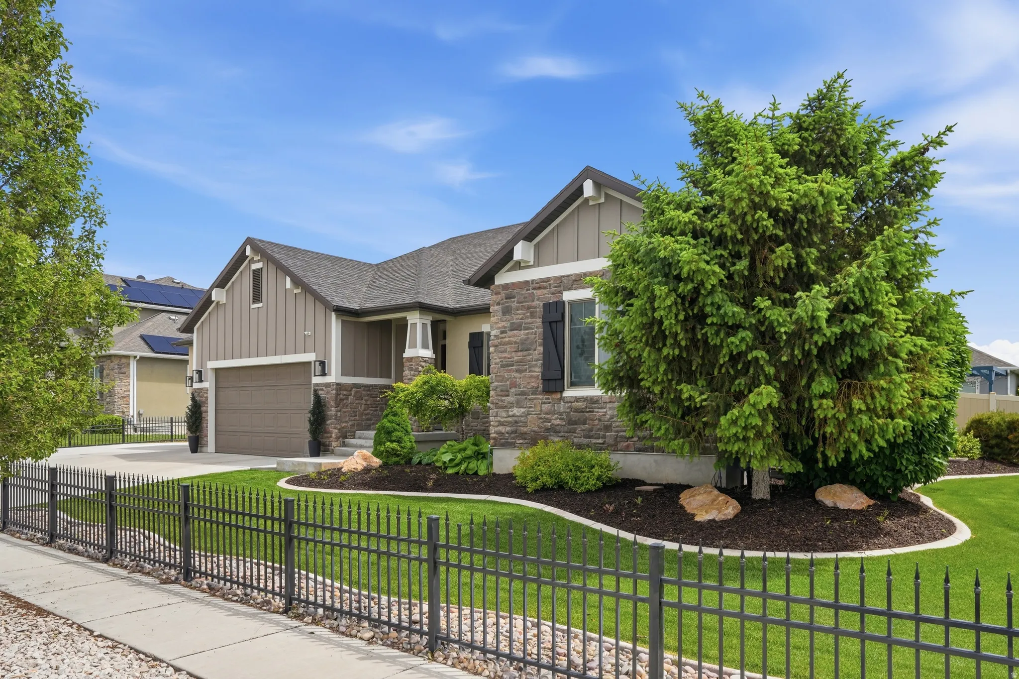 Craftsman-style home featuring a stone and board-and-batten exterior