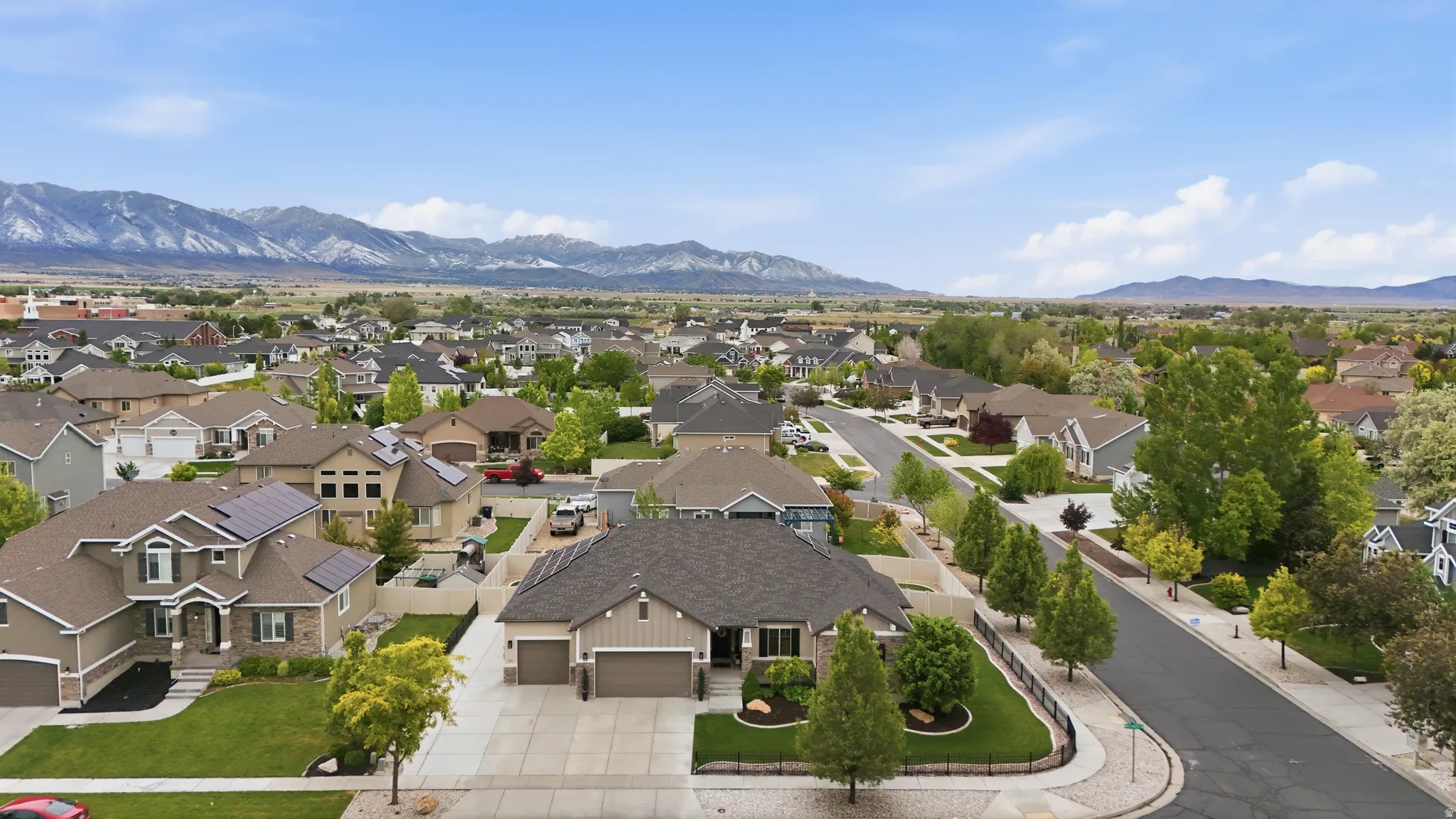 Well-maintained suburban neighborhood with mountain backdrops and established landscaping