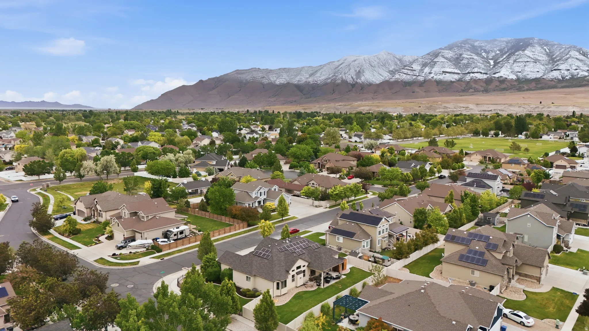 Aerial perspective showcasing a residential neighborhood with varied home styles and mature landscaping