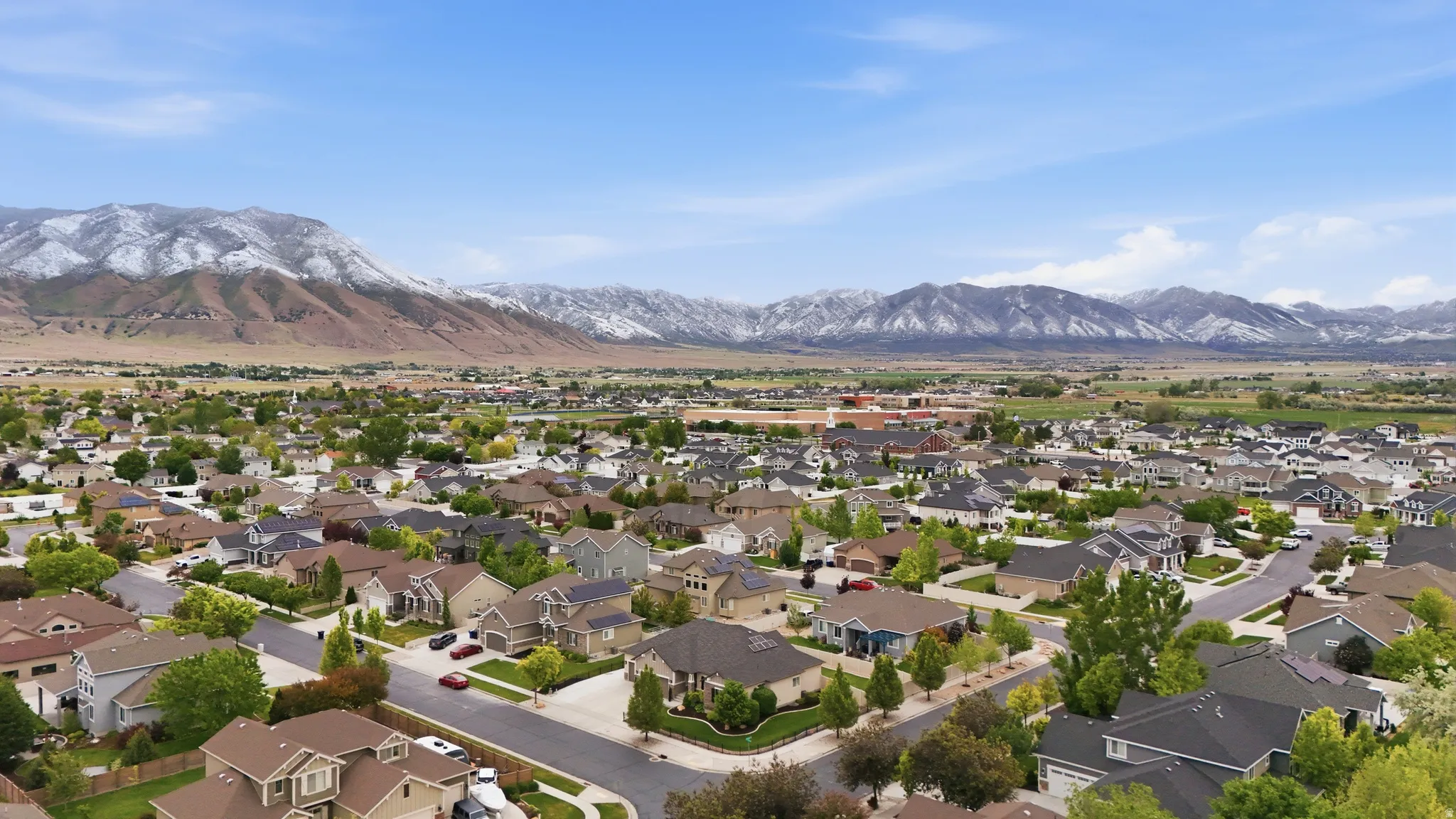 Expansive residential neighborhood featuring a variety of single-family homes, mature street trees, and paved roads