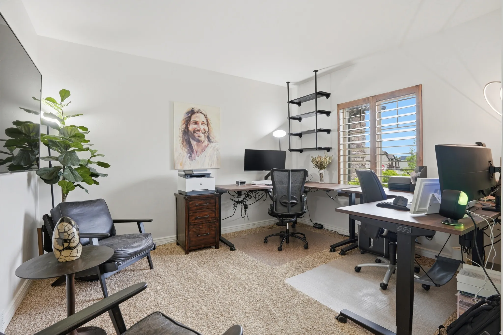 Flexible space with textured carpet flooring and light-toned walls