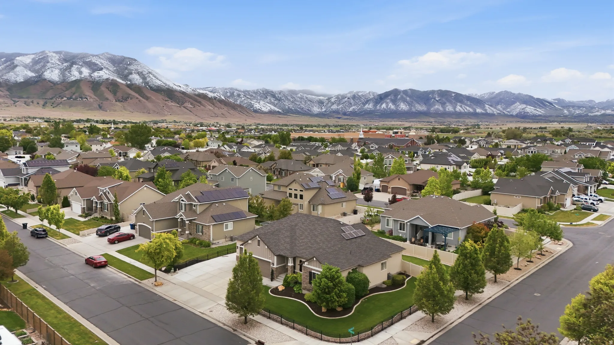Aerial perspective showcasing a residential neighborhood with mountain backdrop