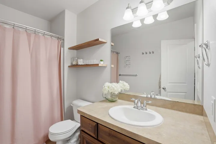 Bathroom featuring a vanity with a light-toned countertop, undermount sink, and chrome fixtures