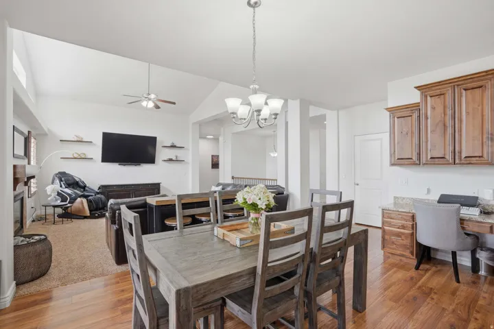 Open concept living space featuring wood-finish flooring and vaulted ceilings