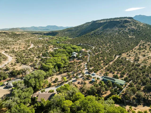 Expansive natural landscape featuring varied terrain, mature trees, and mountainous backdrops