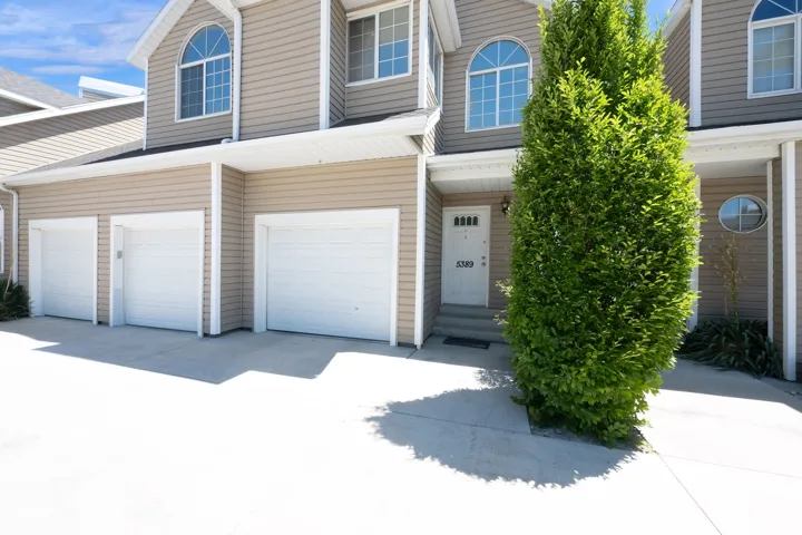 Multi-unit property with a tan siding exterior and white trim accents