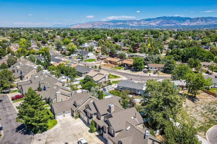 Aerial perspective showcasing a residential community with abundant mature trees and varied architectural styles