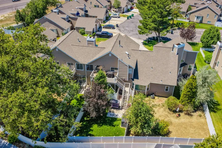 Multi-level townhouse property featuring a private fenced backyard with both manicured lawn and natural areas