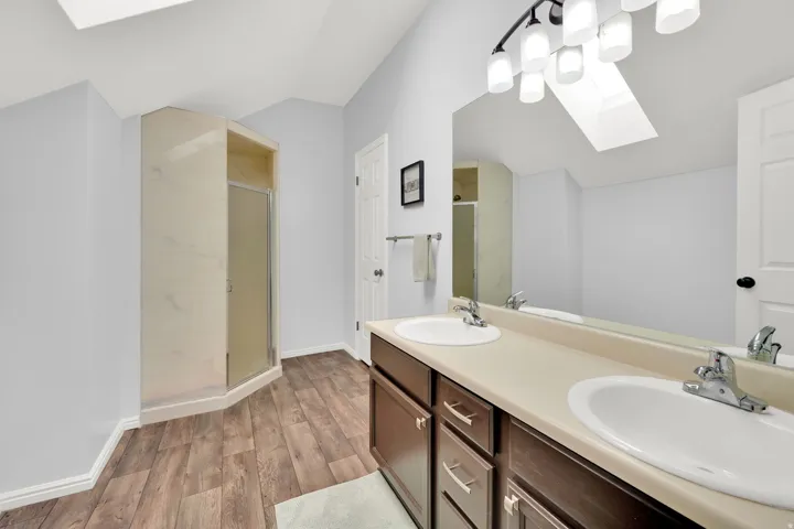 Bathroom featuring a dual vanity with a light-colored countertop and under-mount sinks