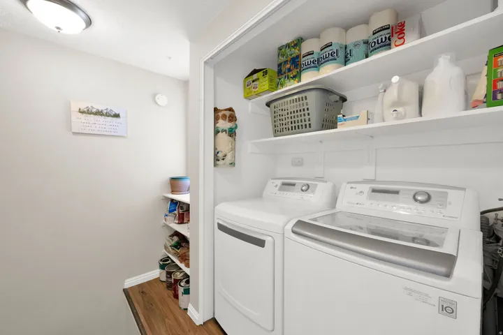 Dedicated laundry area featuring a top-load washer and front-load dryer