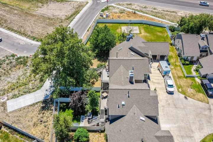Aerial perspective showcasing multiple homes with pitched shingle roofs and chimneys