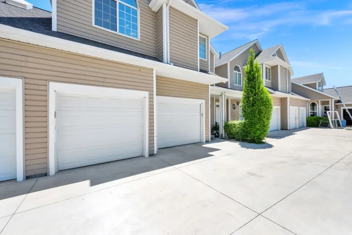Light tan horizontal siding exterior with a white trim package