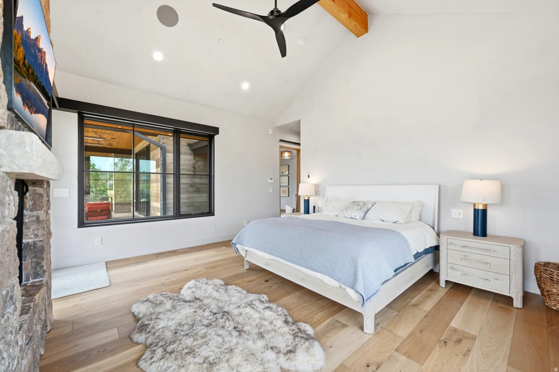 Vaulted ceiling with exposed wood beam and modern ceiling fan
