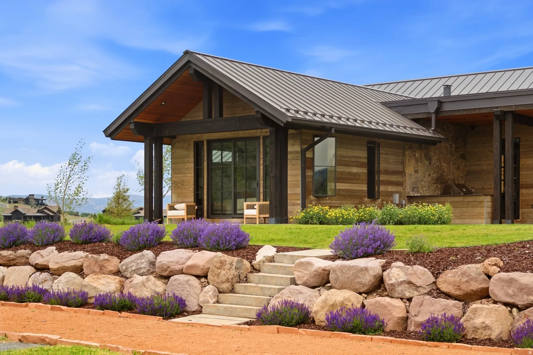 Contemporary home exterior featuring a metal roof and natural wood siding