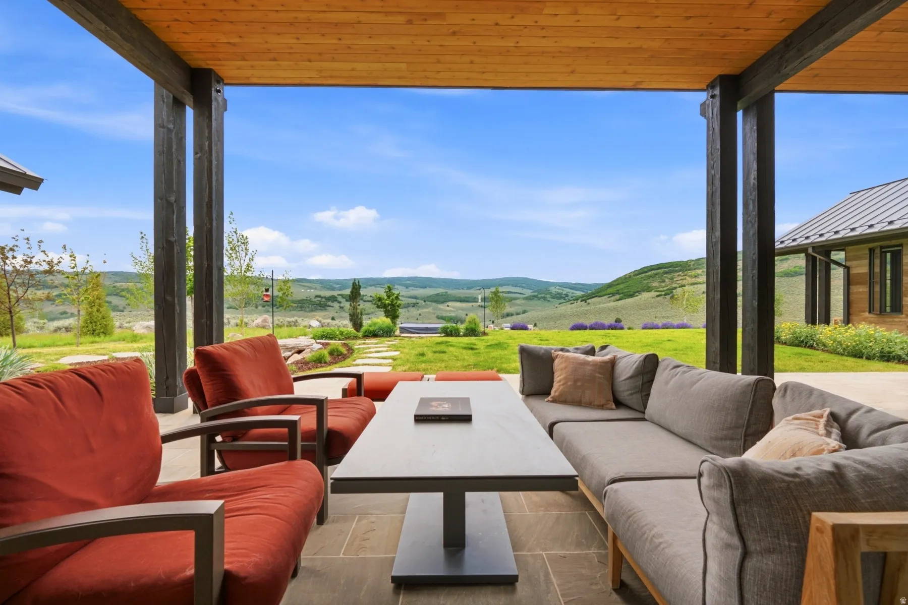 Covered patio with a wood-plank ceiling and exposed beams