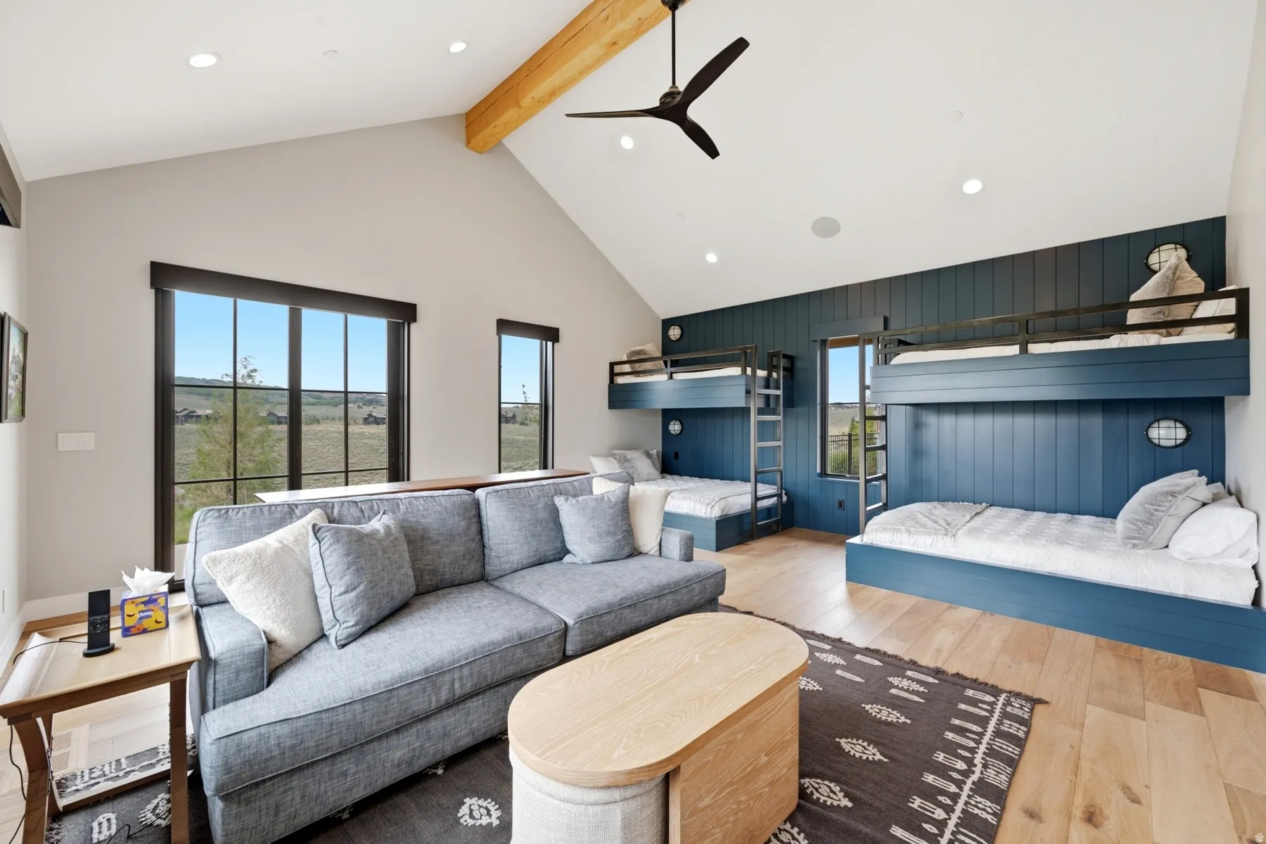 Vaulted ceiling with an exposed wood beam, recessed lighting, and a contemporary ceiling fan