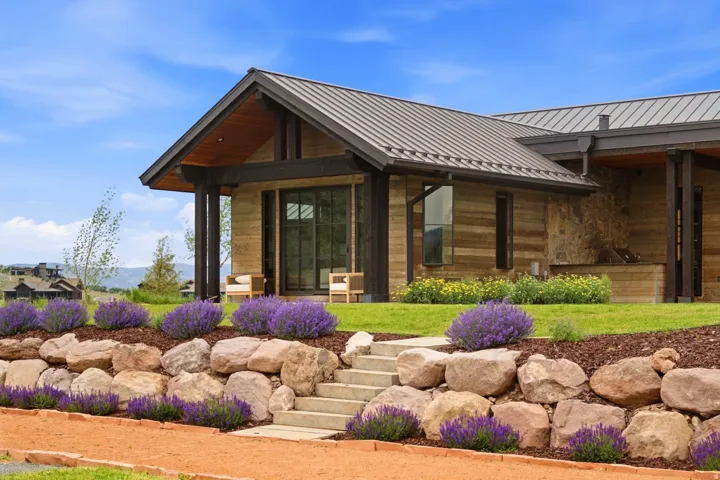 Contemporary home exterior featuring a metal roof and natural wood siding