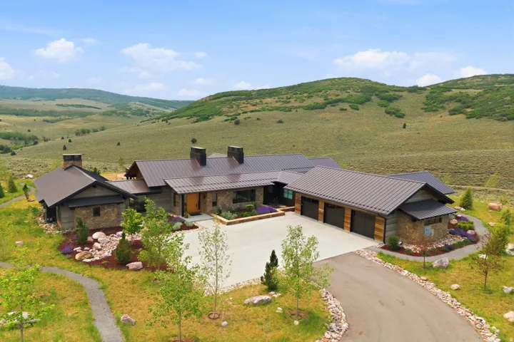 Expansive single-story residence with a multi-gabled metal roof system