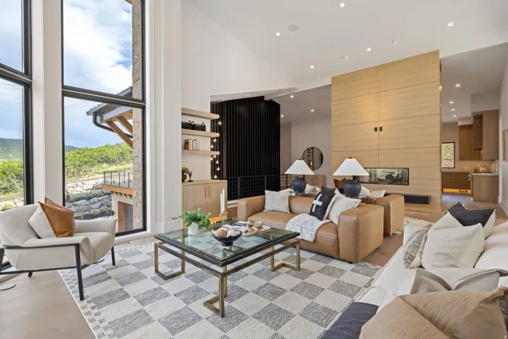 Vaulted ceilings with recessed lighting complement the wood-finish flooring