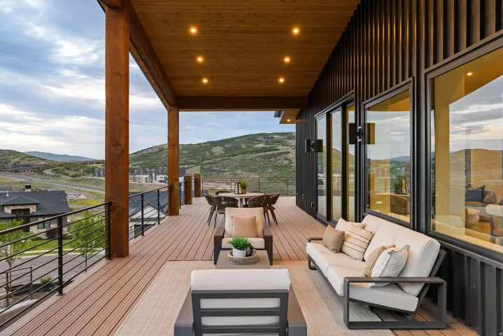 Expansive outdoor deck featuring wood-finish flooring and a wood-paneled ceiling with recessed lighting