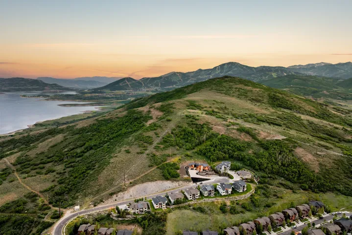 Expansive aerial perspective showcasing a residential development nestled into a verdant hillside