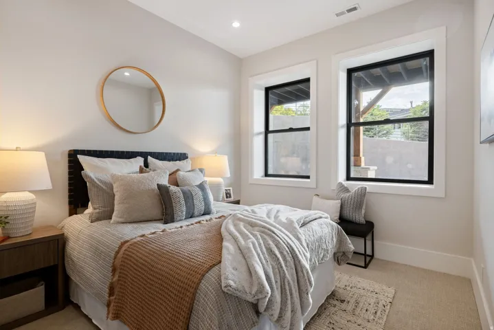 Recessed lighting illuminates neutral-toned walls and plush carpeting