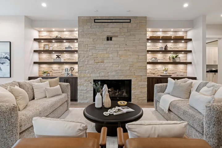Central stone-clad fireplace with a dark firebox and hearth