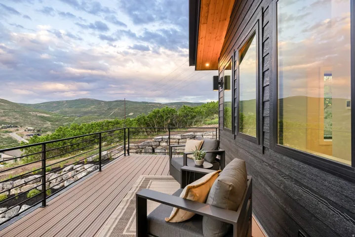 Expansive outdoor deck featuring wood-finish flooring and black metal railing