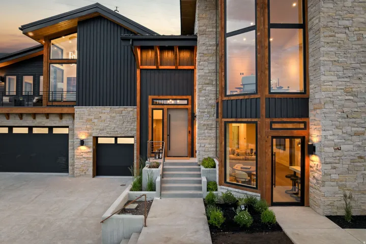 Modern exterior featuring stone and vertical panel siding