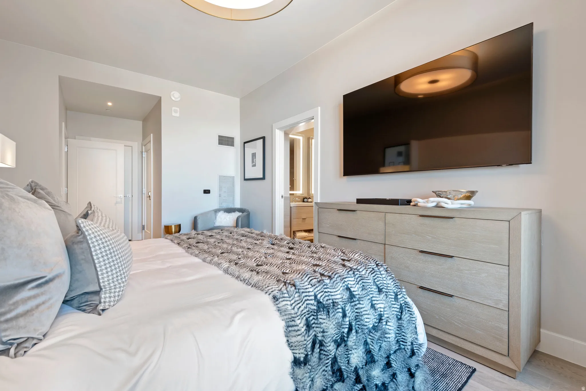 Recessed lighting and a flush-mount ceiling light illuminate the space