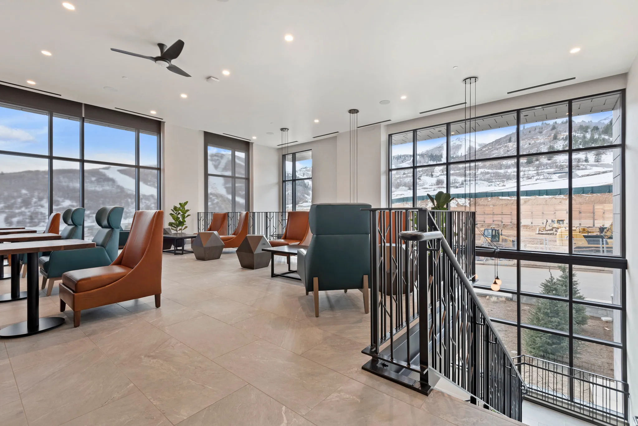 Spacious common area featuring extensive window walls, recessed lighting, and tile flooring