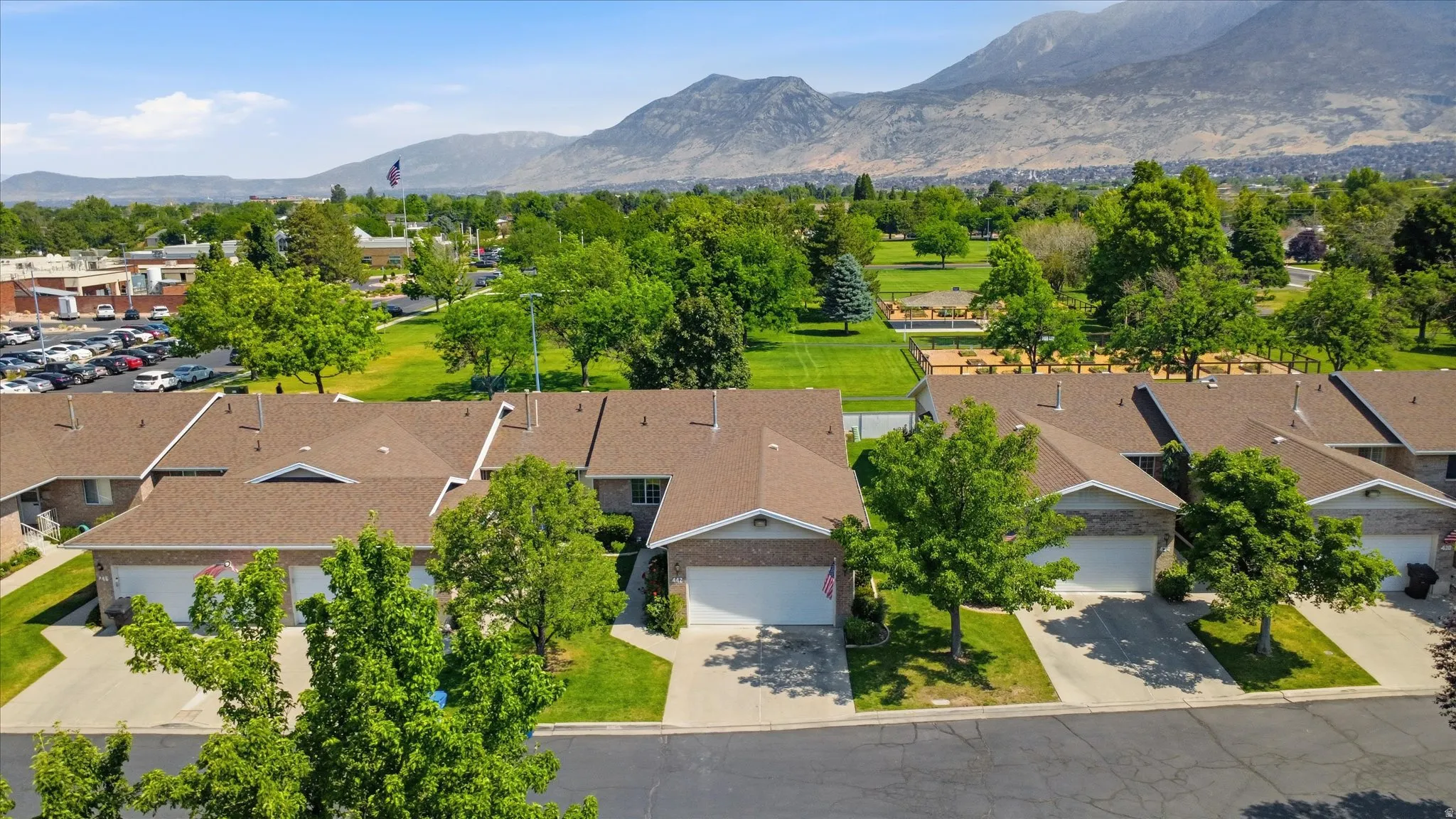 Row of townhomes featuring attached garages and individual driveways
