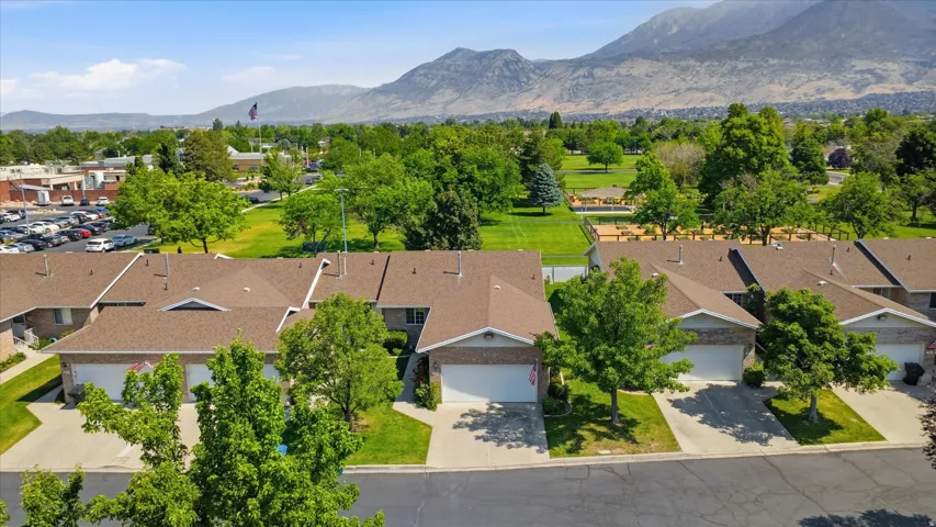 Row of townhomes featuring attached garages and individual driveways