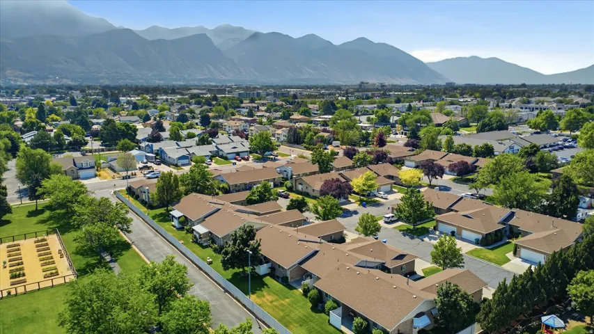 Aerial perspective showcasing a residential community with abundant green spaces and mature trees